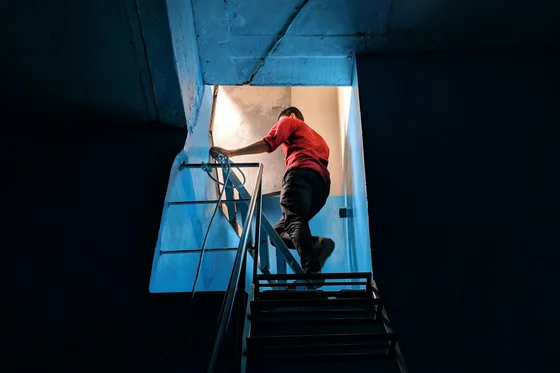 Tradesperson climbing a stairwell on site